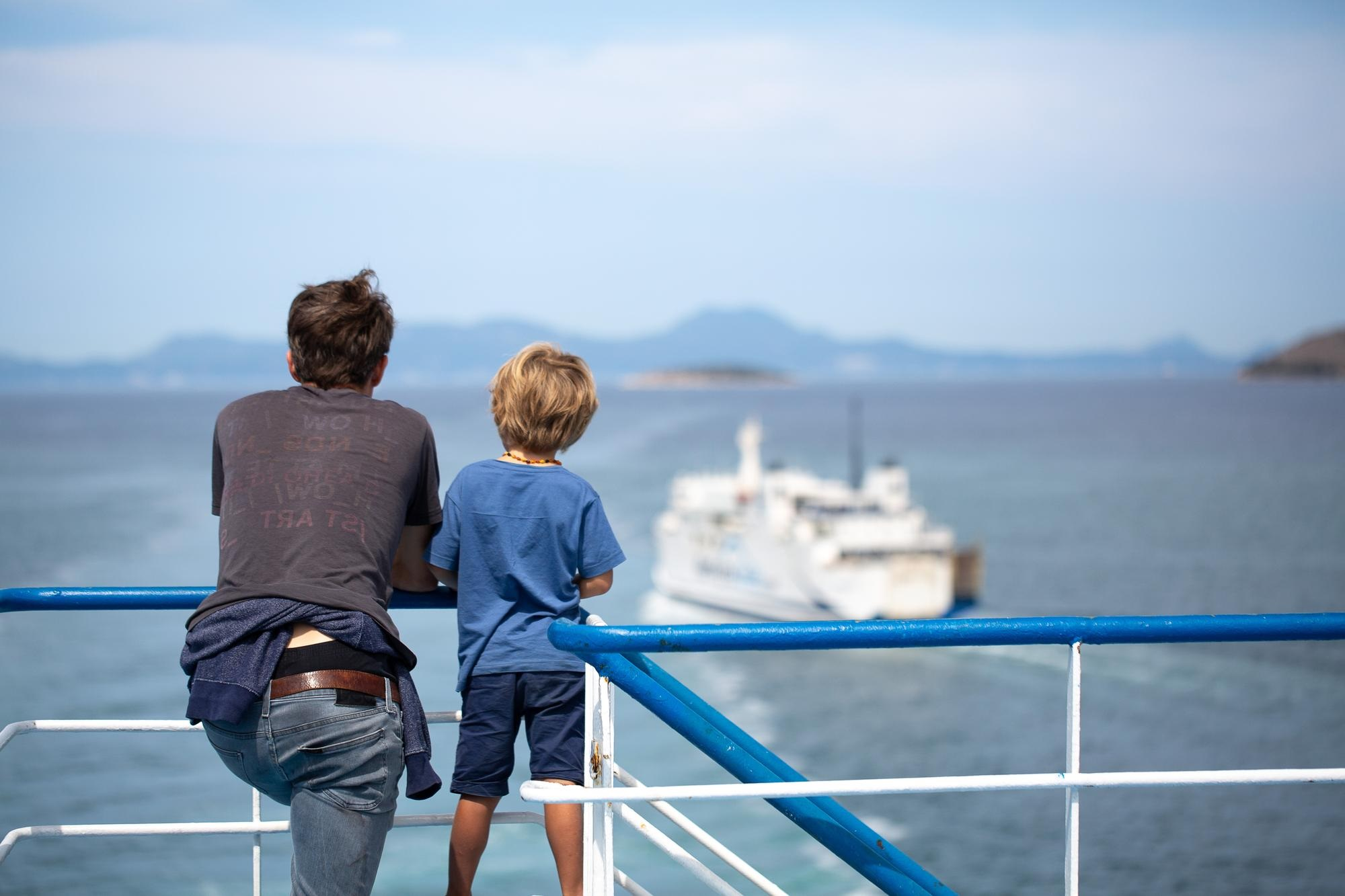 father with his son on cruise deck