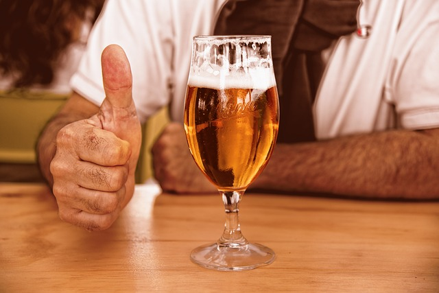 A thumbs up beside a glass of beer