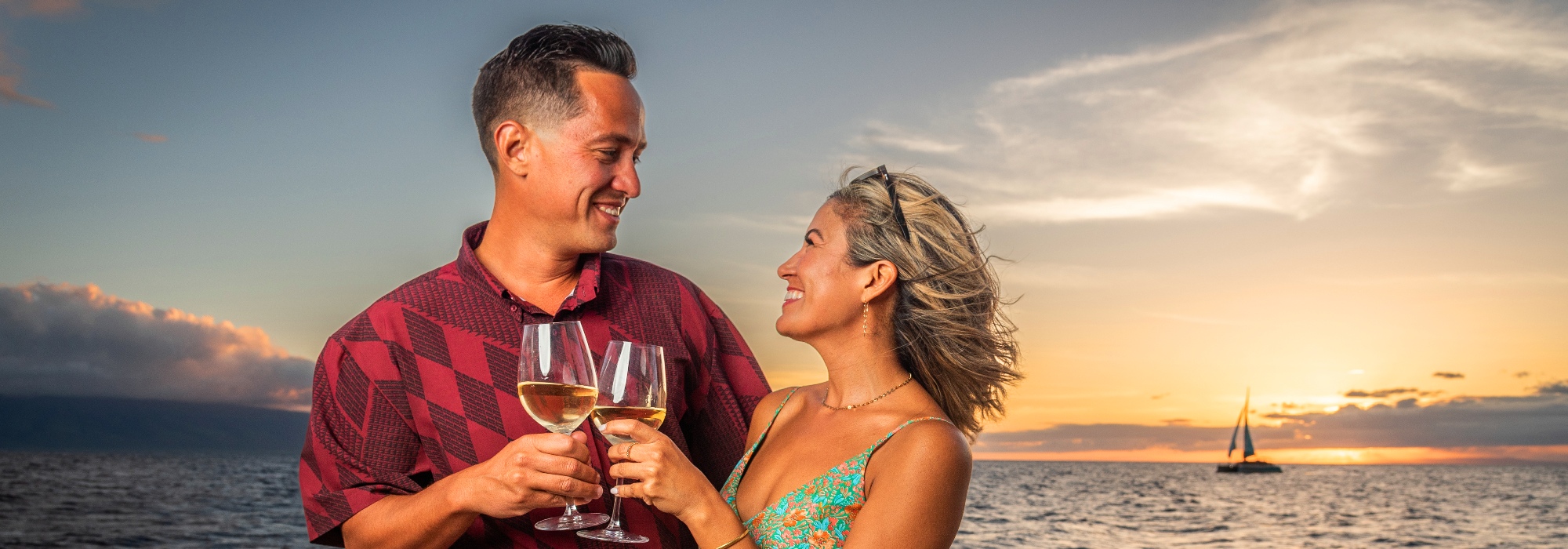 Couple doing a wine toast during sunset