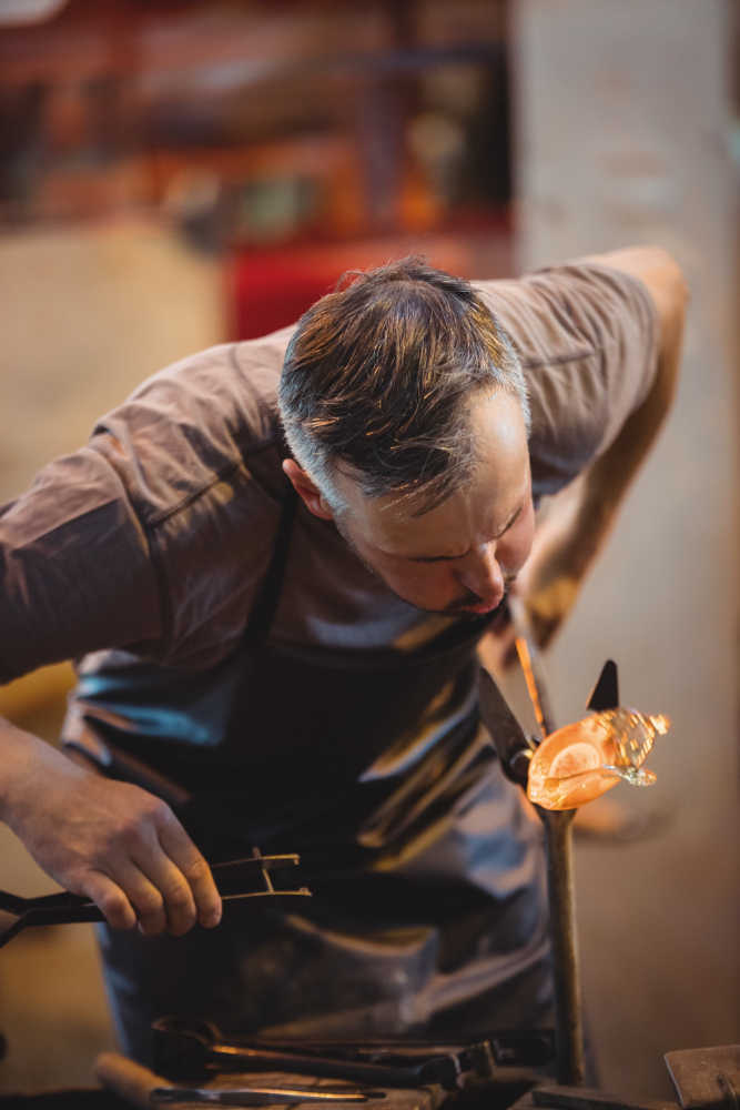 A male glassblower making a vase