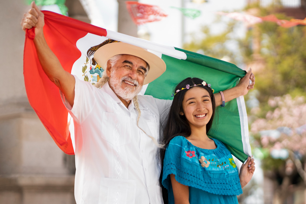 Grandfather and granddaughter holding the Mexican Flag