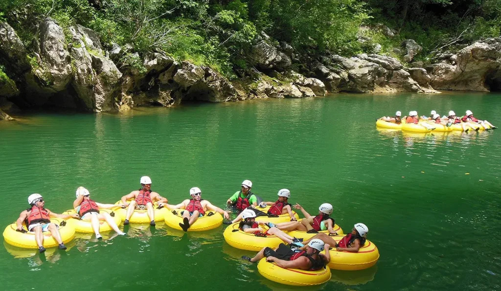 Group of tourists cave tubing in Belize
