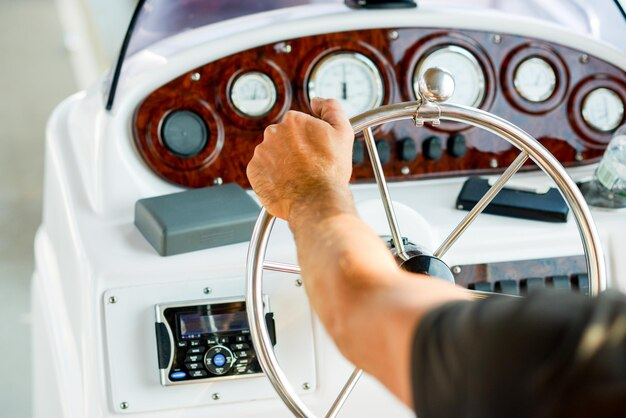 Man holding a ships steering wheel