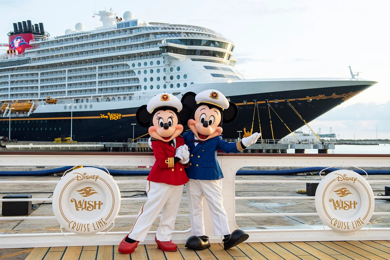 Mickey and Minnie Mouse mascots posing infront of a ship
