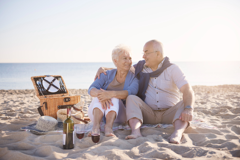 Senior couple having a picnic by the sea
