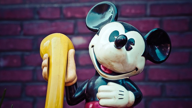 Statue of Mickey Mouse holding a phone