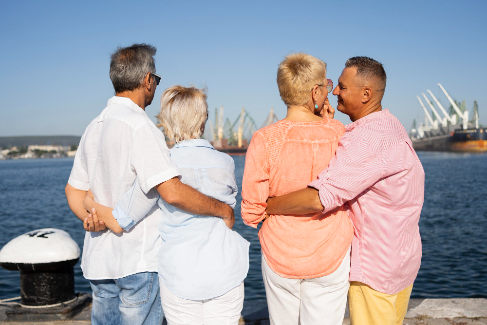 Two pairs of senior citizens looking at a view