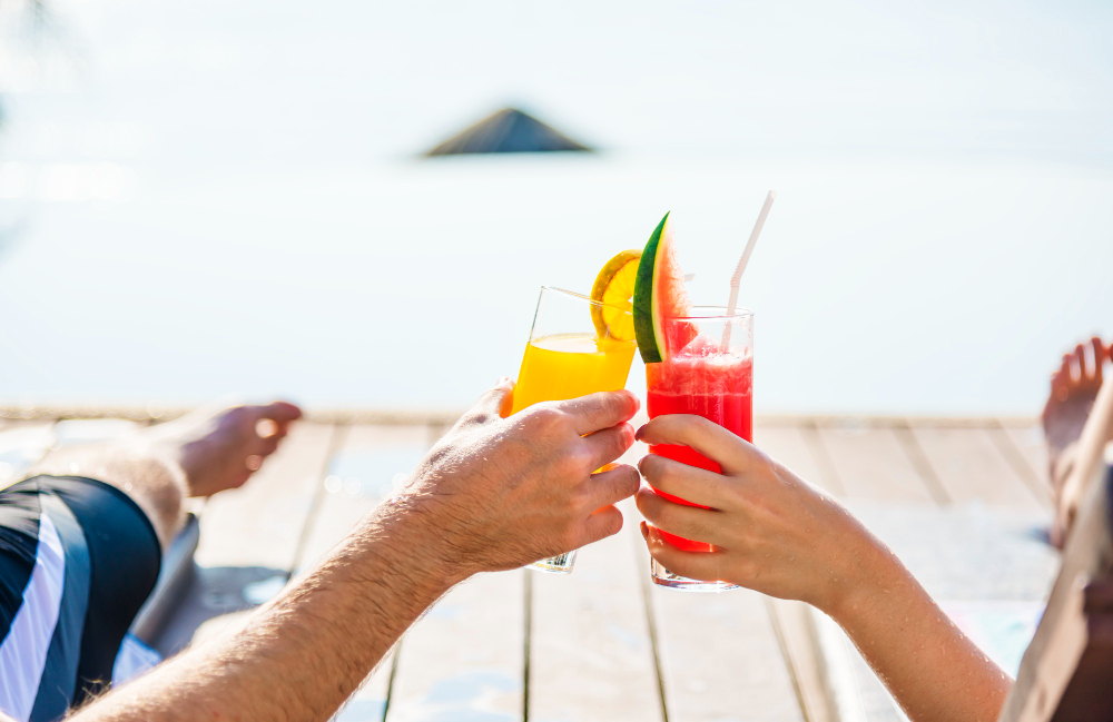 Two people having drinks overlooking the sea