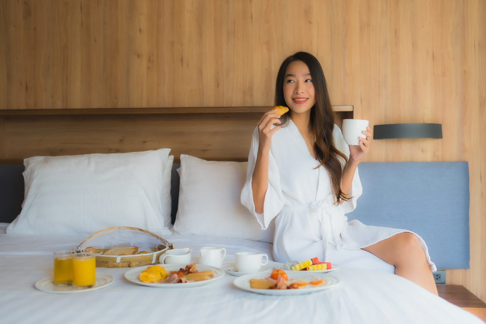 Woman enjoying her breakfast in bed