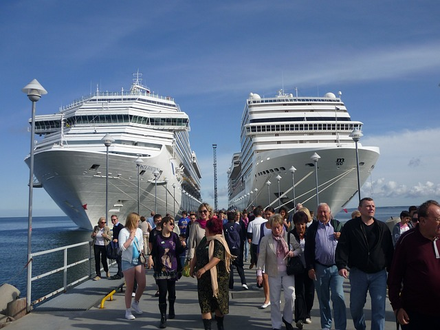 crowd of people offboarding two cruise ships