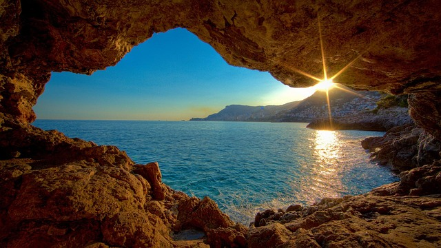 looking through a cave entrance into the sea
