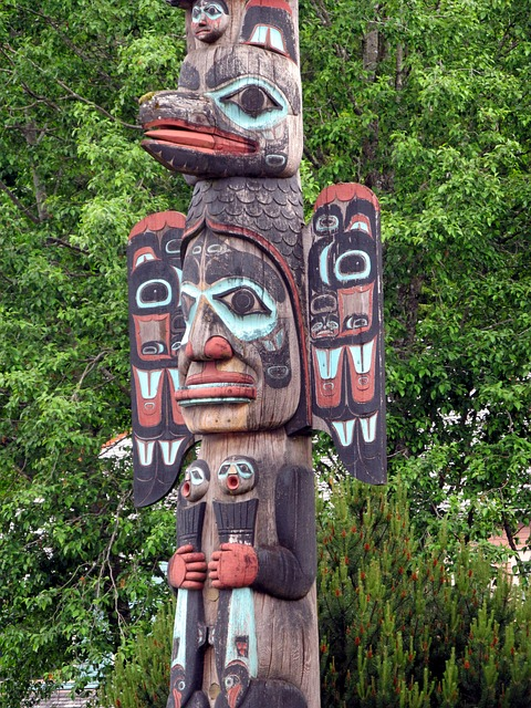 native american totem poles in a forest
