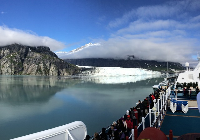 people looking out a cruise deck to the glaciers