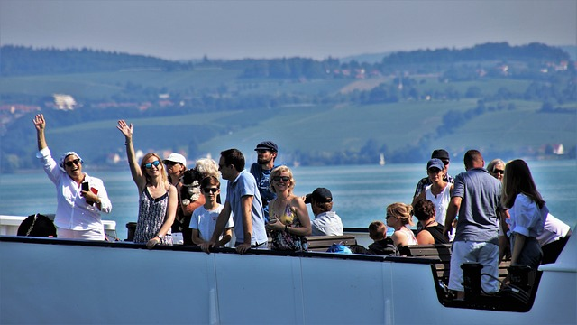 people waving on the top deck of a ship