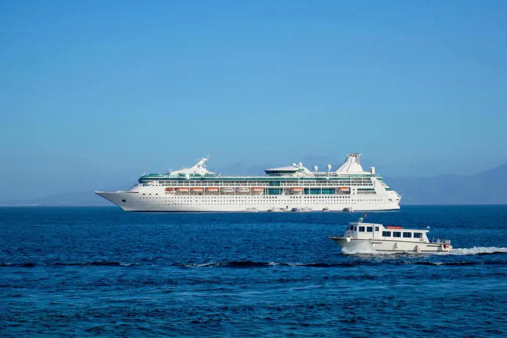 cruise ship beside a yacht on the aegean sea