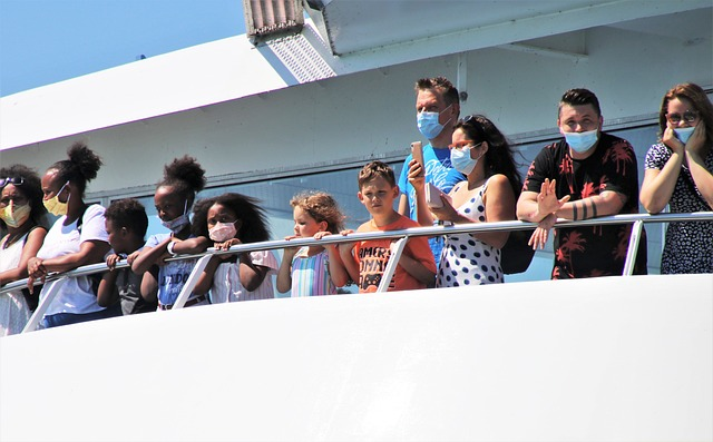 kids and adults wearing mask on a ship deck