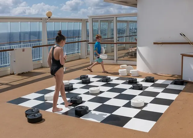 kids playing checkers in their swimsuits