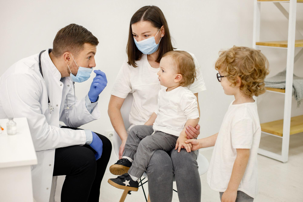 mother with two sons consulting a doctor