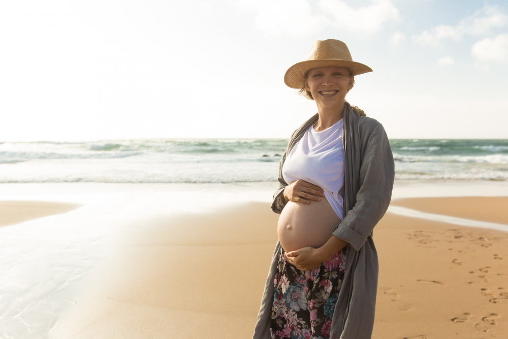 smiling pregnant woman in a hat