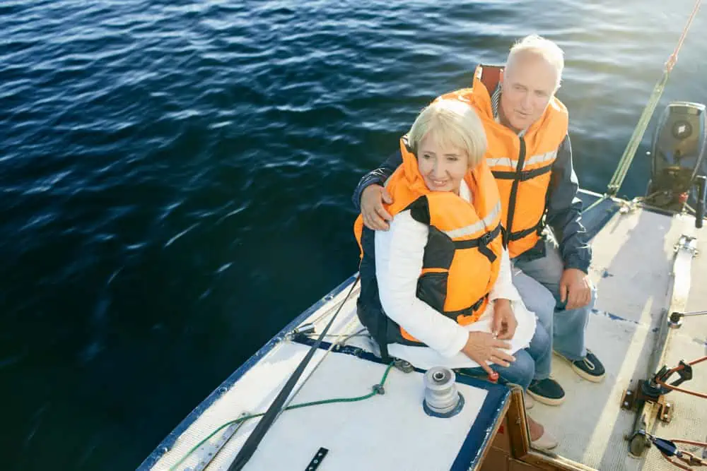 senior couple wearing a life jacket smiling